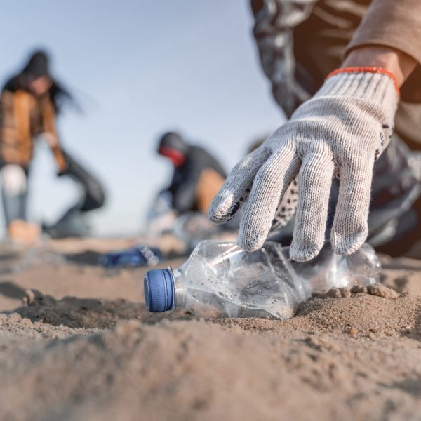 Volunteer,Man,Collecting,Trash,On,The,Beach.,Ecology,Concept